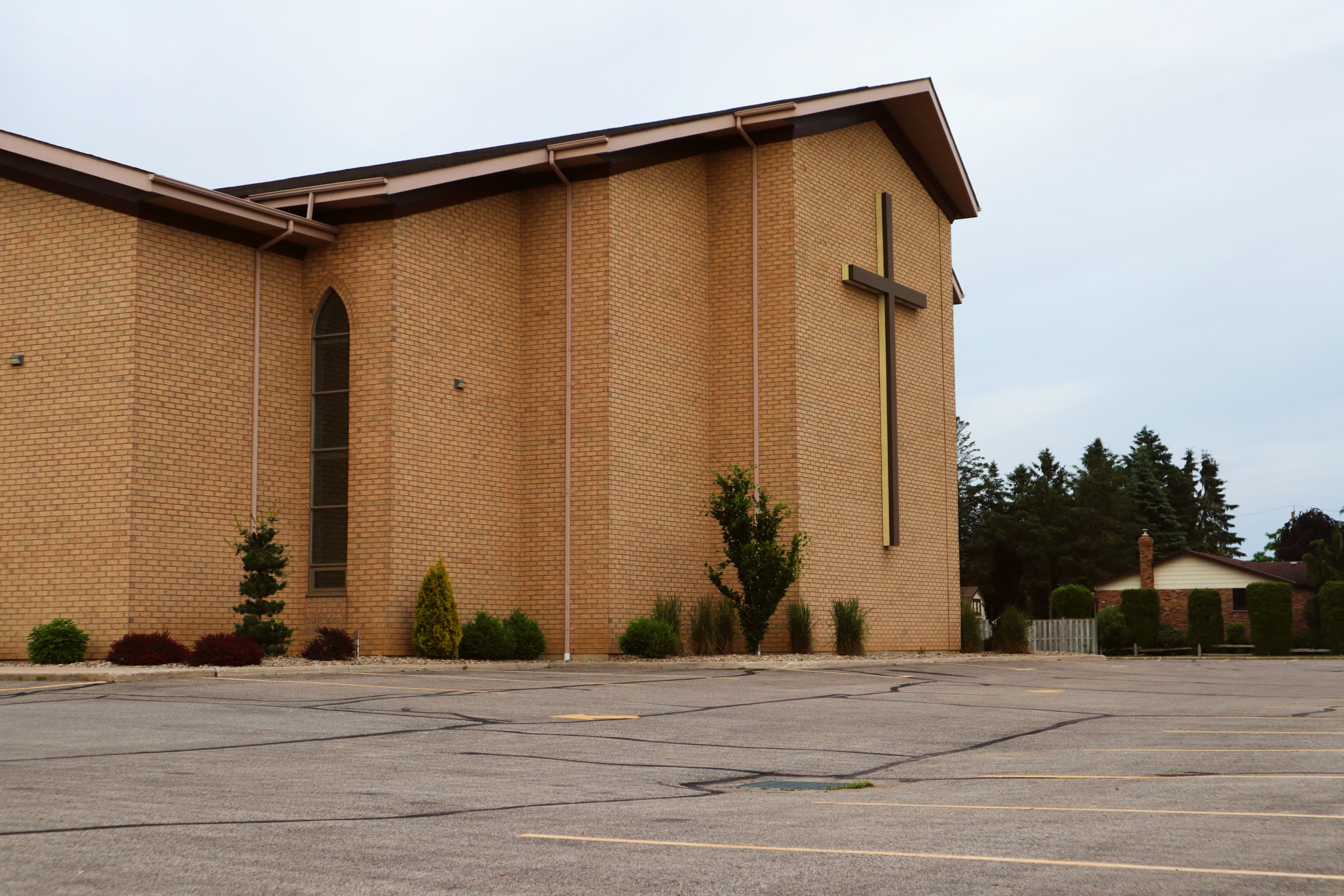 Modern church exterior with a tall cross — clean architectural lines